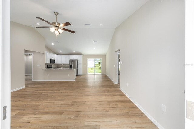 1059 NE 130th Ter, Silver Springs, FL 34488 - unfurnished living room with ceiling fan, high vaulted ceiling, light wood-style floors, and recessed lighting