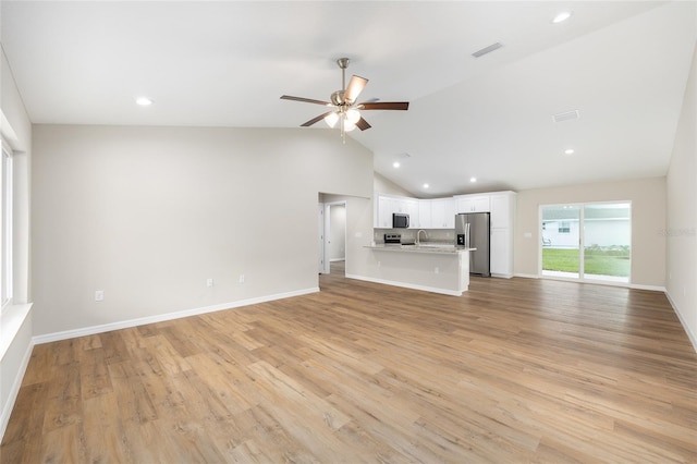1059 NE 130th Ter, Silver Springs, FL 34488 - unfurnished living room featuring recessed lighting, a ceiling fan, lofted ceiling, and light wood finished floors