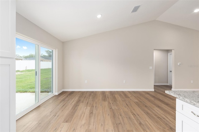 1059 NE 130th Ter, Silver Springs, FL 34488 - unfurnished living room with lofted ceiling, light wood-style flooring, and recessed lighting
