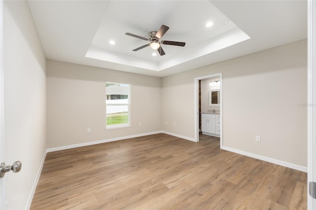 1059 NE 130th Ter, Silver Springs, FL 34488 - empty room with ceiling fan, a tray ceiling, recessed lighting, and light wood-style floors