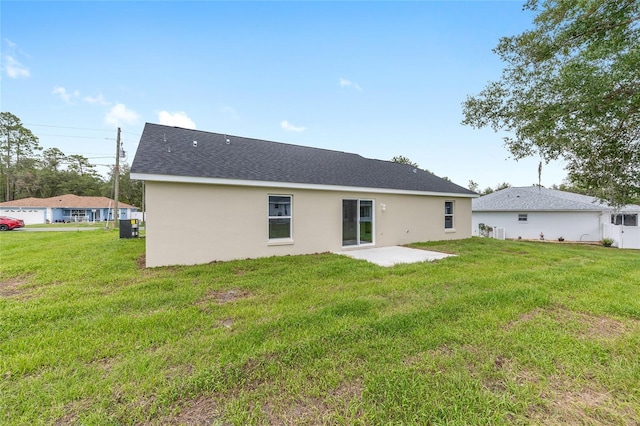 1059 NE 130th Ter, Silver Springs, FL 34488 - back of house with a yard, stucco siding, and a patio