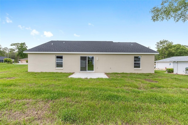 1059 NE 130th Ter, Silver Springs, FL 34488 - rear view of property featuring a patio area, stucco siding, and a lawn
