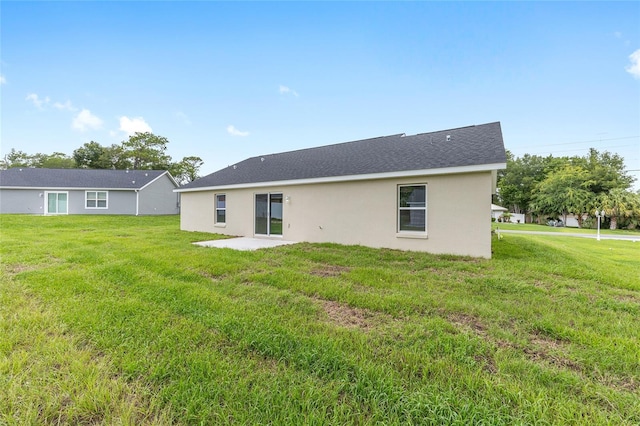 1059 NE 130th Ter, Silver Springs, FL 34488 - rear view of house with a lawn, stucco siding, and a patio