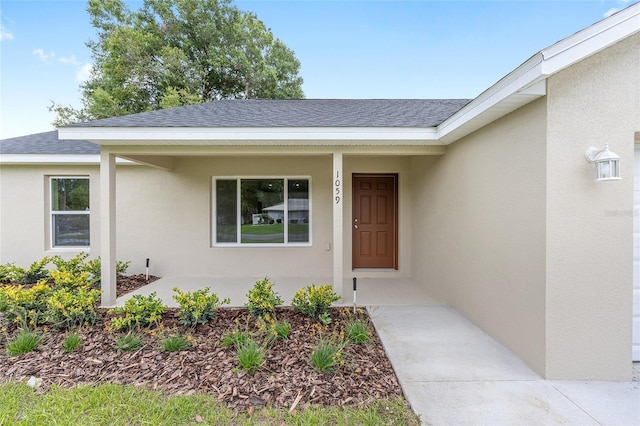 1059 NE 130th Ter, Silver Springs, FL 34488 - doorway to property featuring a shingled roof and stucco siding