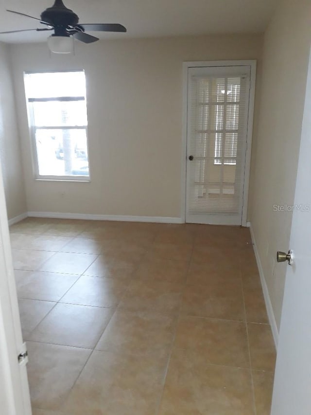 5725 Gatlin Ave Unit 315, Orlando, FL 32822 - spare room with ceiling fan and light tile patterned flooring