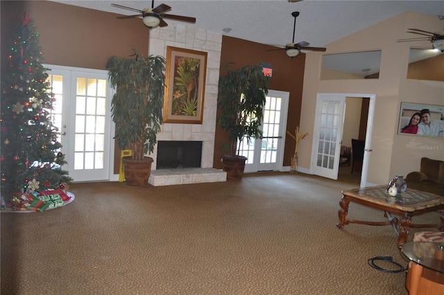 5725 Gatlin Ave Unit 315, Orlando, FL 32822 - living room featuring a ceiling fan, lofted ceiling, carpet flooring, french doors, and a large fireplace