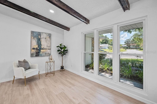 3029 Pinetree, Winter Haven, FL 33884 - sitting room featuring beamed ceiling, light wood finished floors, and a textured ceiling