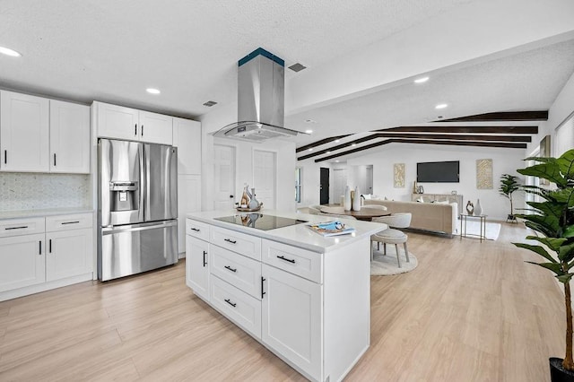 3029 Pinetree, Winter Haven, FL 33884 - kitchen featuring stainless steel fridge with ice dispenser, island range hood, black electric cooktop, light wood-style floors, and white cabinets
