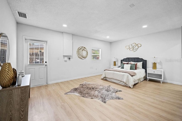 3029 Pinetree, Winter Haven, FL 33884 - bedroom with light wood finished floors, multiple windows, a textured ceiling, and recessed lighting