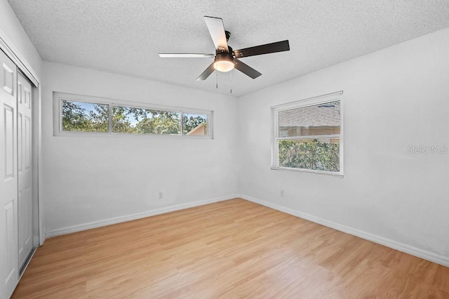 3029 Pinetree, Winter Haven, FL 33884 - unfurnished bedroom with light wood-type flooring, a closet, a textured ceiling, and ceiling fan