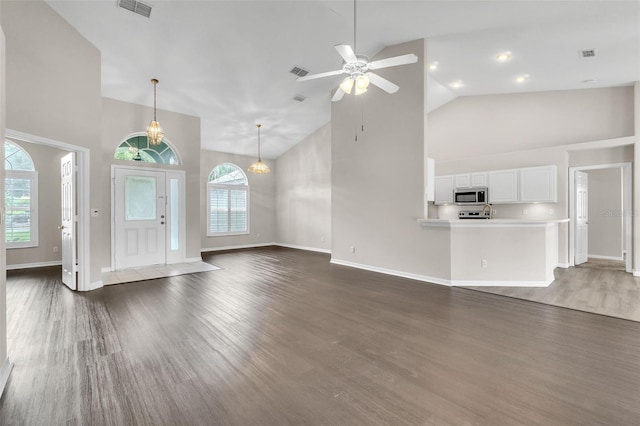 2675 Bond St, Clermont, FL 34711 - unfurnished living room featuring high vaulted ceiling, dark wood-style flooring, and a ceiling fan