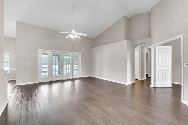2675 Bond St, Clermont, FL 34711 - unfurnished living room featuring ceiling fan, arched walkways, high vaulted ceiling, healthy amount of natural light, and dark wood-style flooring
