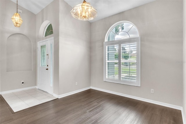 2675 Bond St, Clermont, FL 34711 - entrance foyer featuring a chandelier, wood finished floors, and a high ceiling