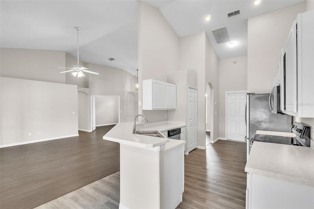 2675 Bond St, Clermont, FL 34711 - kitchen featuring high vaulted ceiling, arched walkways, appliances with stainless steel finishes, open floor plan, and light countertops