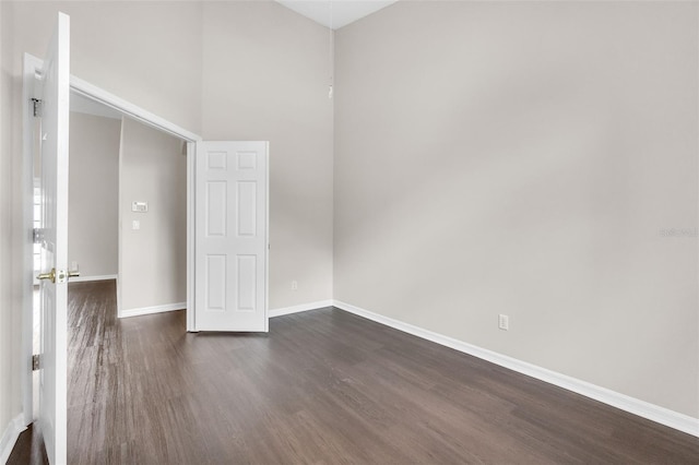 2675 Bond St, Clermont, FL 34711 - empty room featuring dark wood-style flooring and a towering ceiling