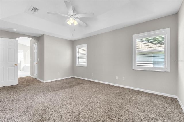 2675 Bond St, Clermont, FL 34711 - carpeted empty room with ceiling fan, arched walkways, and a raised ceiling