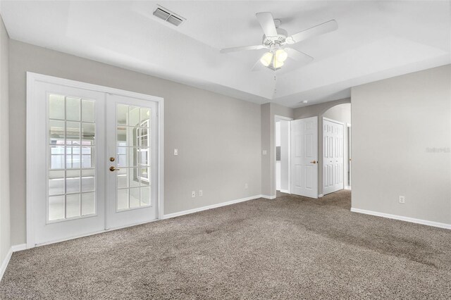 2675 Bond St, Clermont, FL 34711 - spare room featuring french doors, carpet floors, a ceiling fan, and arched walkways