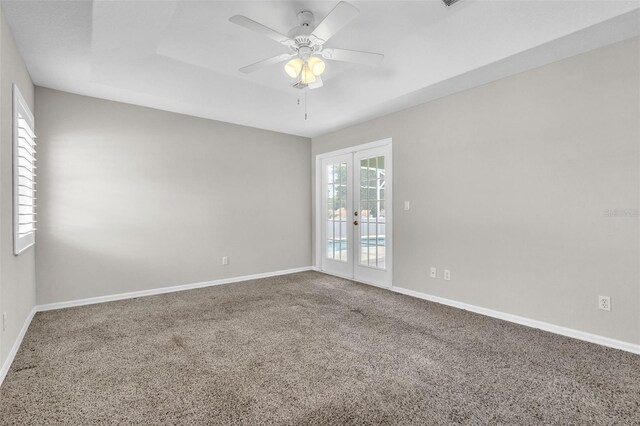 2675 Bond St, Clermont, FL 34711 - unfurnished room featuring french doors, carpet floors, ceiling fan, and a tray ceiling