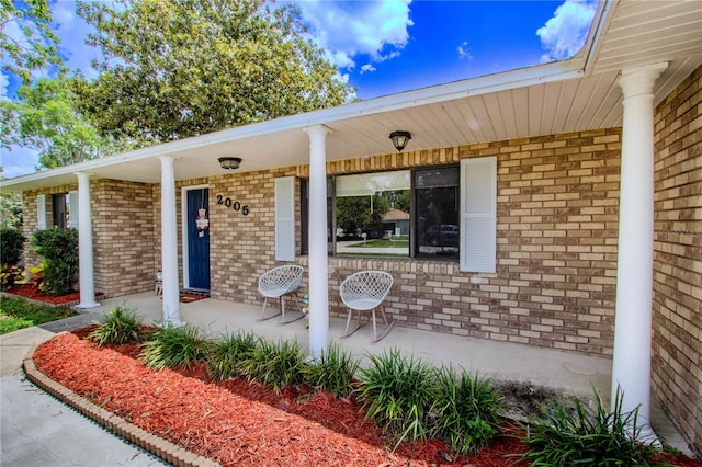 2005 Dalton Ave, Deltona, FL 32725 - view of exterior entry with covered porch and brick siding
