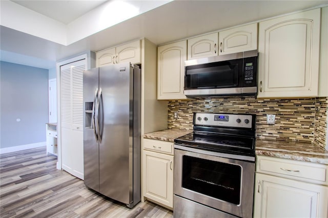 2005 Dalton Ave, Deltona, FL 32725 - kitchen featuring stainless steel appliances, light wood finished floors, tasteful backsplash, and light stone counters