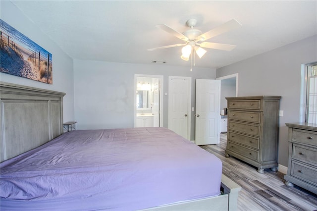 2005 Dalton Ave, Deltona, FL 32725 - bedroom with light wood-type flooring, connected bathroom, and ceiling fan