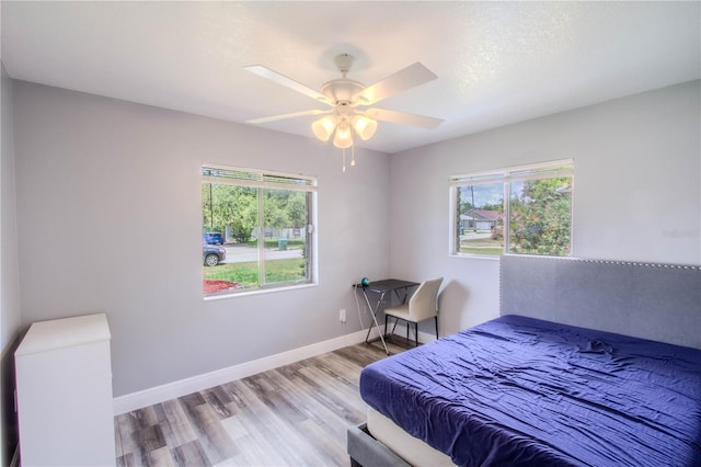 2005 Dalton Ave, Deltona, FL 32725 - bedroom featuring wood finished floors, multiple windows, and ceiling fan