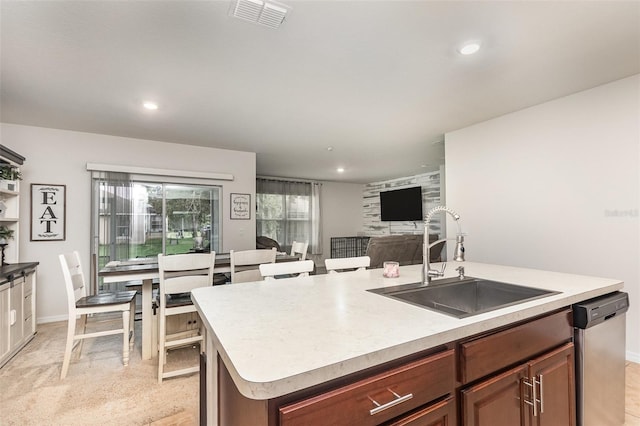 1010 Morvan Ln, Kissimmee, FL 34759 - kitchen featuring dishwasher, light countertops, an island with sink, recessed lighting, and open floor plan