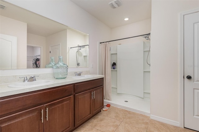 1010 Morvan Ln, Kissimmee, FL 34759 - bathroom with a stall shower, tile patterned flooring, double vanity, and a walk in closet