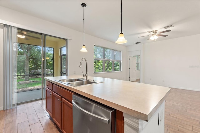 519 Cadiz Dr, Davenport, FL 33837 - kitchen featuring dishwasher, light countertops, brown cabinets, decorative light fixtures, and an island with sink