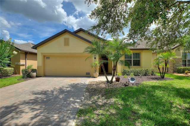 519 Cadiz Dr, Davenport, FL 33837 - single story home featuring stucco siding, a garage, decorative driveway, and a front yard