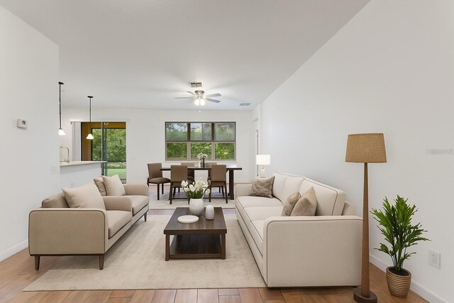 519 Cadiz Dr, Davenport, FL 33837 - living room with light wood finished floors and a ceiling fan