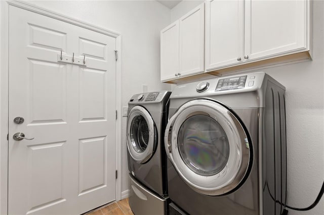 519 Cadiz Dr, Davenport, FL 33837 - laundry area featuring cabinet space, washer and clothes dryer, and light wood-style flooring