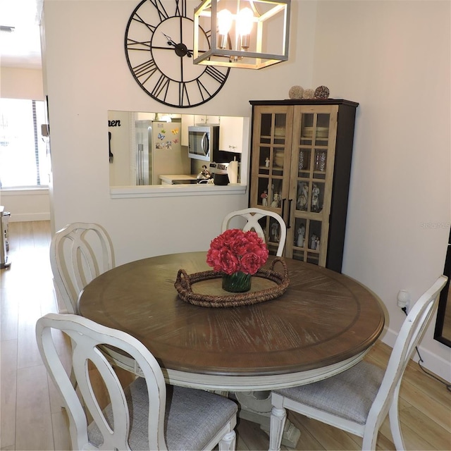 2480 Tahoe Cir Unit 2480, Winter Park, FL 32792 - dining room featuring a chandelier and wood finished floors