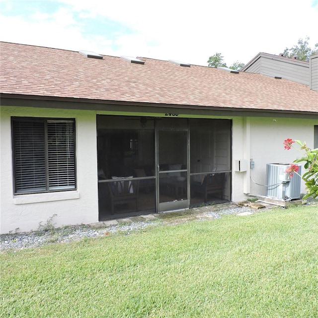 2480 Tahoe Cir Unit 2480, Winter Park, FL 32792 - back of property with roof with shingles, a yard, a sunroom, and stucco siding