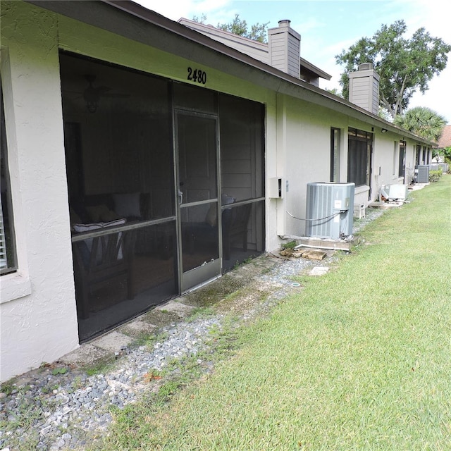 2480 Tahoe Cir Unit 2480, Winter Park, FL 32792 - view of side of home with a chimney, stucco siding, and a lawn