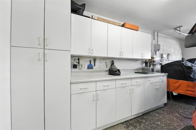1430 Challenger Ave, Davenport, FL 33897 - kitchen featuring light countertops, white cabinetry, decorative backsplash, and a textured ceiling