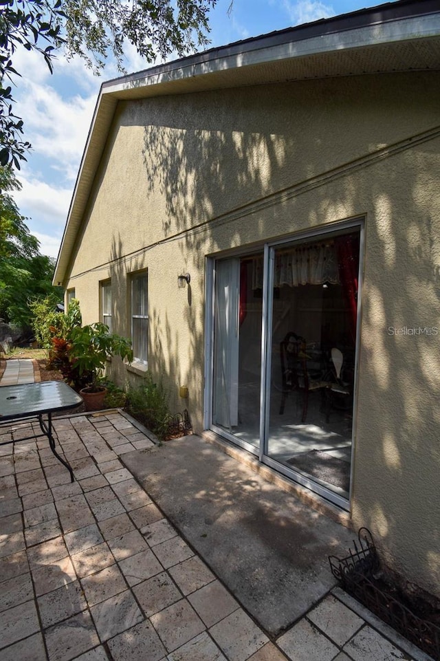 1436 Swan Ct, Kissimmee, FL 34759 - rear view of house featuring a patio area and stucco siding