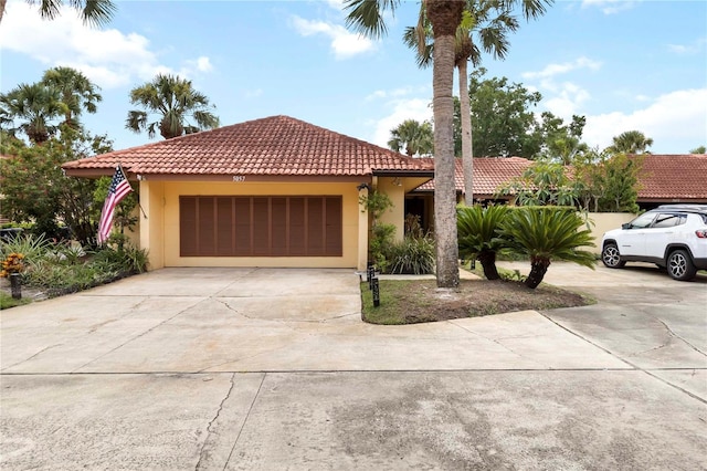 5057 Maui Cir Unit 15, Orlando, FL 32808 - mediterranean / spanish-style home with a tile roof, driveway, and stucco siding