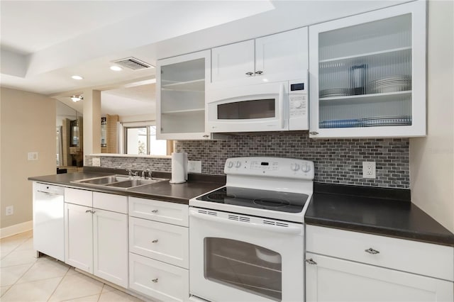 5057 Maui Cir Unit 15, Orlando, FL 32808 - kitchen featuring white appliances, tasteful backsplash, dark countertops, white cabinetry, and recessed lighting