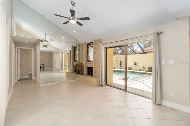5057 Maui Cir Unit 15, Orlando, FL 32808 - unfurnished living room featuring ceiling fan, a fireplace, lofted ceiling, recessed lighting, and light tile patterned flooring