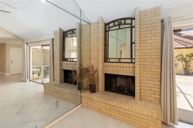 5057 Maui Cir Unit 15, Orlando, FL 32808 - unfurnished living room with a fireplace, vaulted ceiling, tile patterned flooring, and healthy amount of natural light