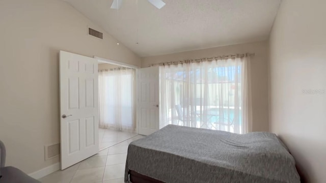 5057 Maui Cir Unit 15, Orlando, FL 32808 - bedroom with vaulted ceiling, light tile patterned floors, and ceiling fan