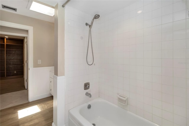 5057 Maui Cir Unit 15, Orlando, FL 32808 - full bath with wood finished floors, shower / bath combination, and wainscoting