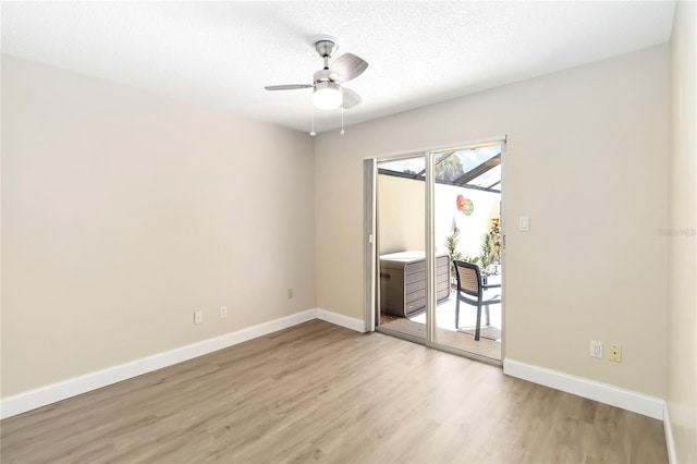 5057 Maui Cir Unit 15, Orlando, FL 32808 - unfurnished room with light wood finished floors, ceiling fan, and a textured ceiling