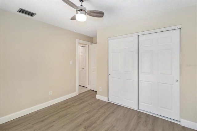 5057 Maui Cir Unit 15, Orlando, FL 32808 - unfurnished bedroom with light wood-style floors, a closet, and ceiling fan
