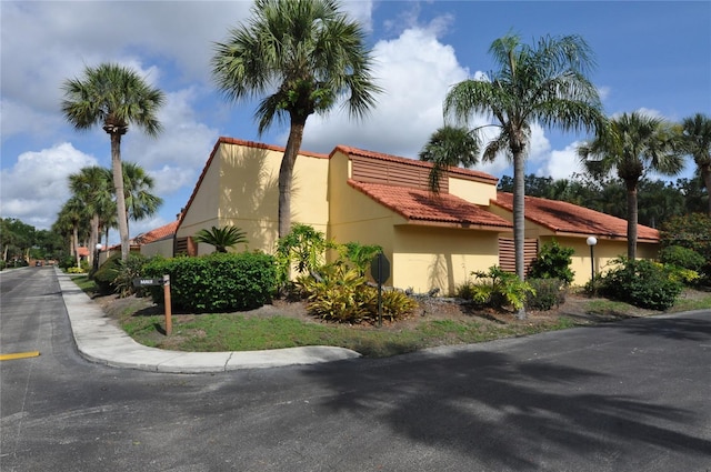 5057 Maui Cir Unit 15, Orlando, FL 32808 - view of property exterior with a tile roof and stucco siding