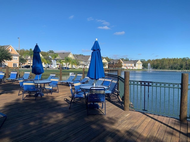 4019 Venetian Bay Dr Unit 107, Kissimmee, FL 34741 - deck featuring outdoor dining area, a water view, and a residential view