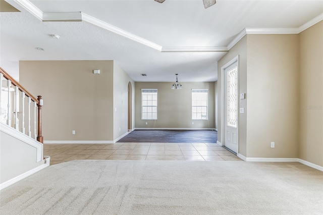 7184 Maleberry Run, Winter Garden, FL 34787 - carpeted entrance foyer featuring tile patterned flooring, a chandelier, stairway, ornamental molding, and arched walkways