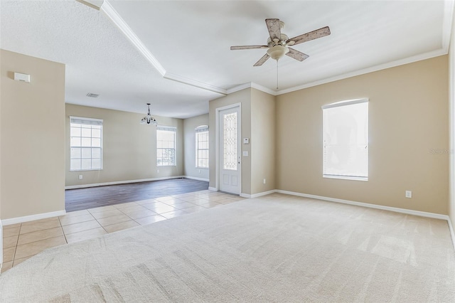 7184 Maleberry Run, Winter Garden, FL 34787 - tiled spare room with a chandelier, a ceiling fan, crown molding, and carpet floors