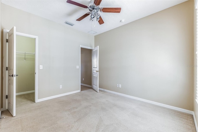 7184 Maleberry Run, Winter Garden, FL 34787 - unfurnished bedroom with light carpet, a walk in closet, a closet, and ceiling fan